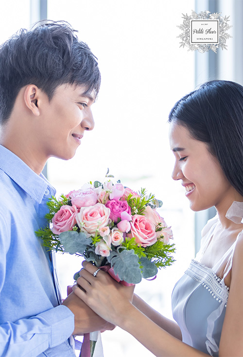 Image of a happy couple with a bouquet of flowers